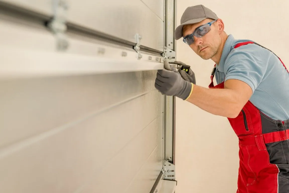 An Image of a guy fixing garage door in Levittown, PA
